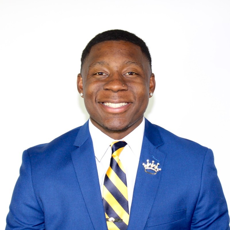 Jahi Chatman smiling in a suit 