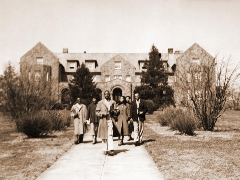 A small group of students on the path from Connor Hall