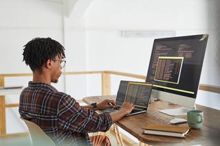 A man coding on a computer