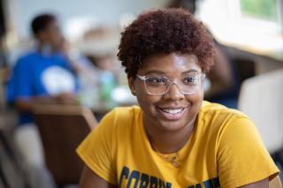 Student in gold Coppin shirt